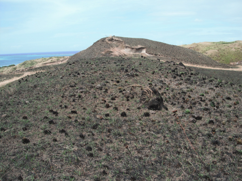 Hilly barren landscape with low burnt browned grass