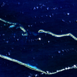 A satellite image of the rectangular ring of Majuro Atoll in the midst of a blue sea.