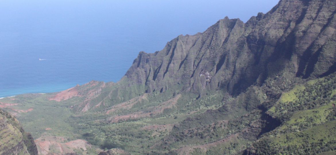 Overview of a large Hawaiian valley, looking out to the sea beyond