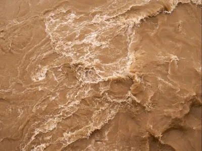 Vaguely abstract overhead image of brown turbulent river waters