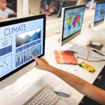 Children sit in front of a computer learning about climate.