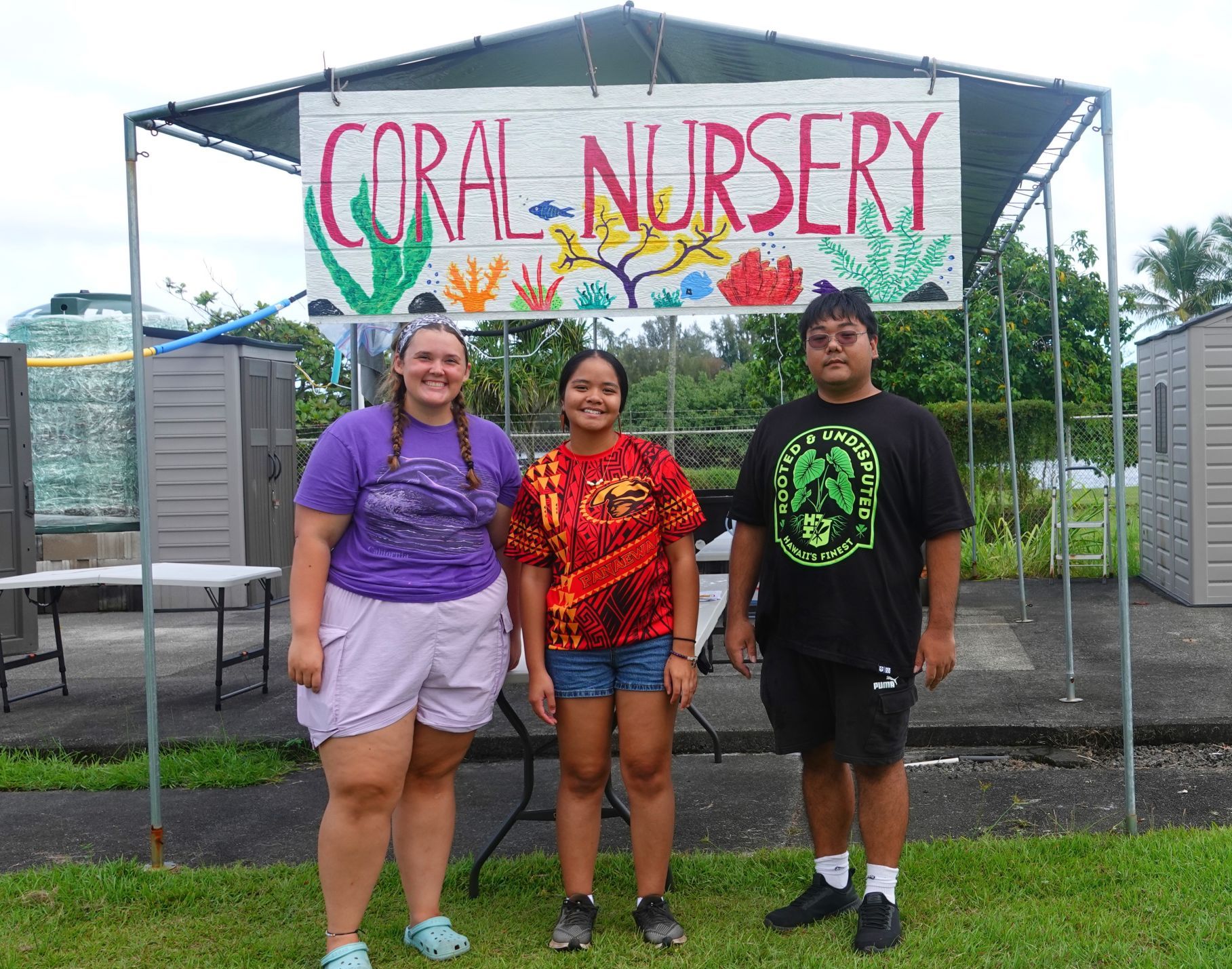 Students pose in front of the PACRC Coral Nursery after co-facilitating the coral lesson.