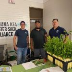 The group stands behind their booth at the fair.